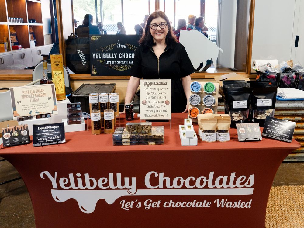 Interior view of Yelibelly Chocolates retail store showing chocolate display cases and branded signage.