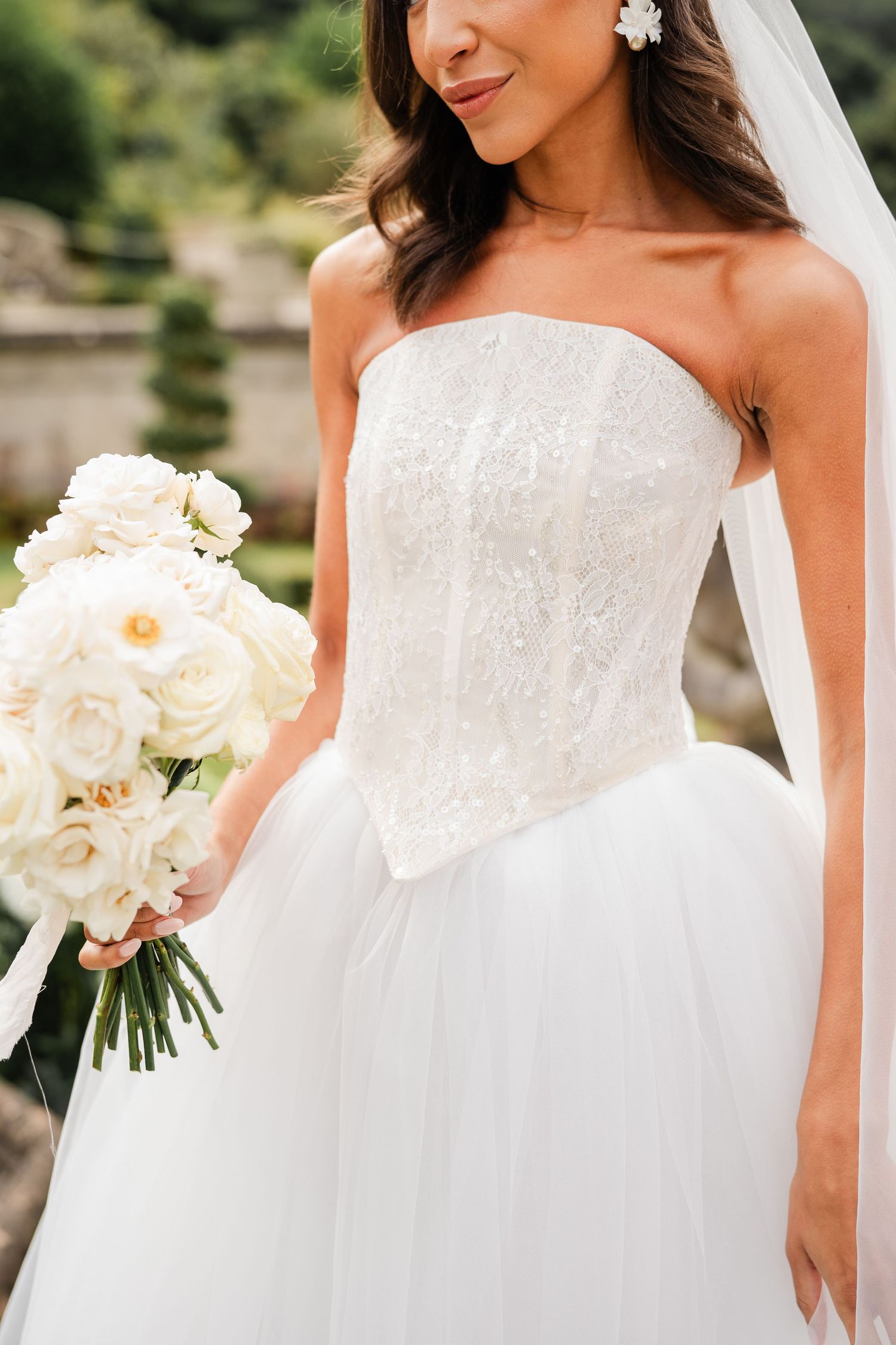 Elegant white wedding dress details with delicate lace bodice and flowing fabric shown in multiple angles.
