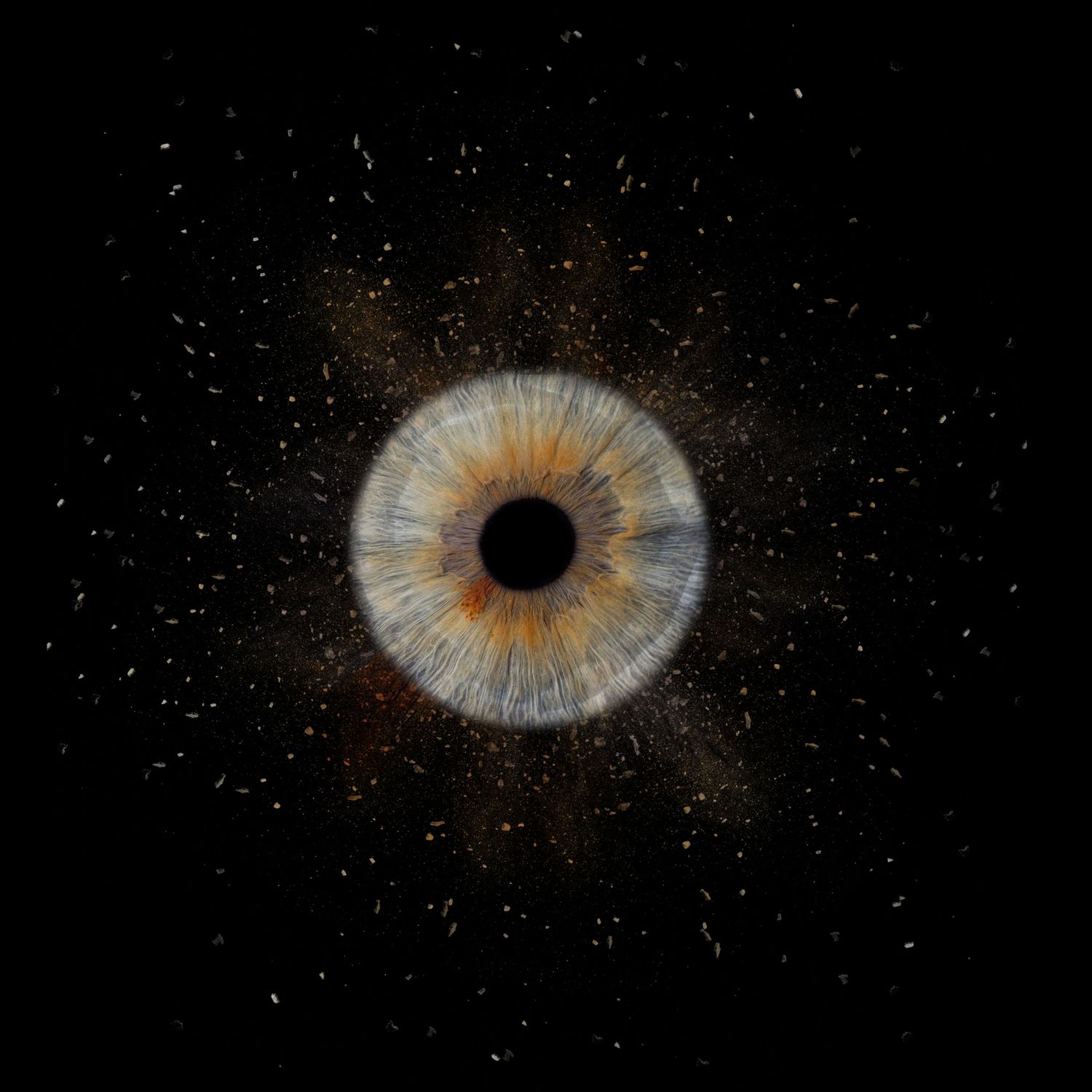 A macro close-up view of a human iris with blue and brown colors surrounded by starry sparkles against black background.