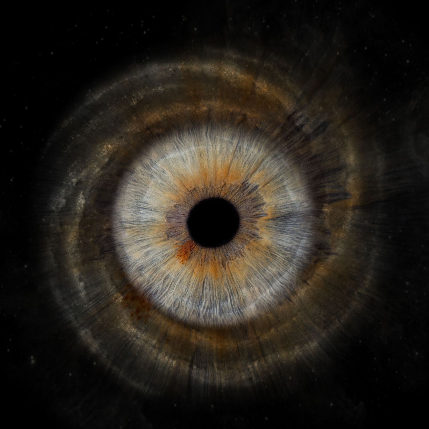 An extreme macro photograph of a human iris shows intricate amber and brown patterns radiating from the dark pupil center.