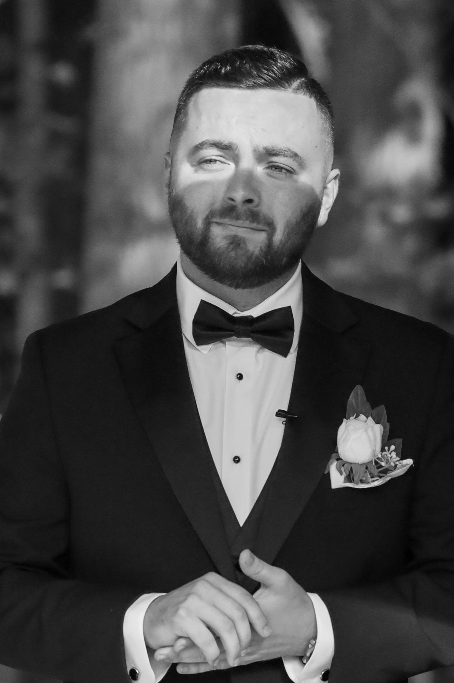 A close-up progression of black and white images showing someone adjusting their formal bowtie and tuxedo.
