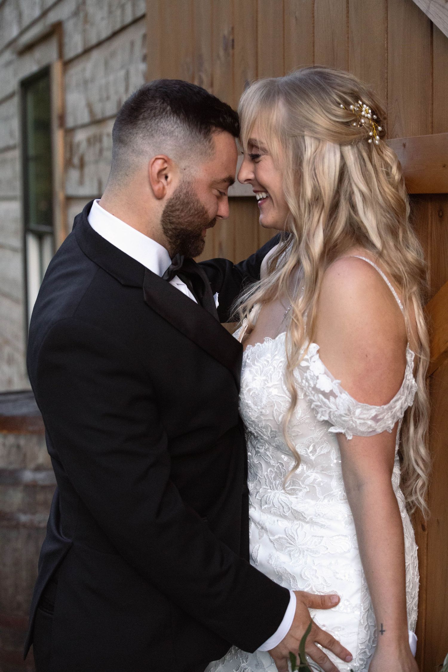 Romantic sequence showing tender moments between newlyweds against rustic wooden wall.