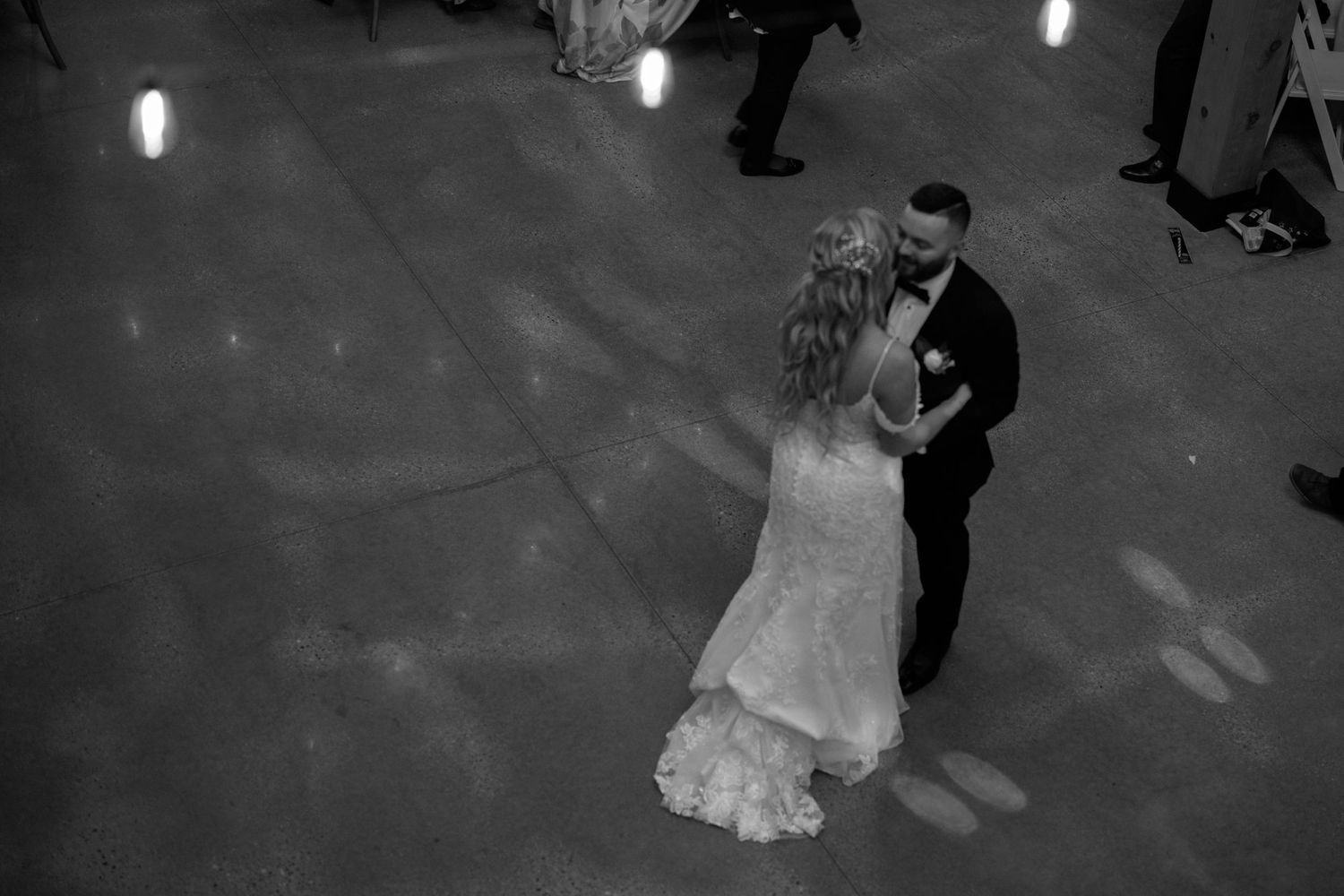 A black and white sequence shows a couple dancing gracefully across a ballroom floor at their wedding celebration.