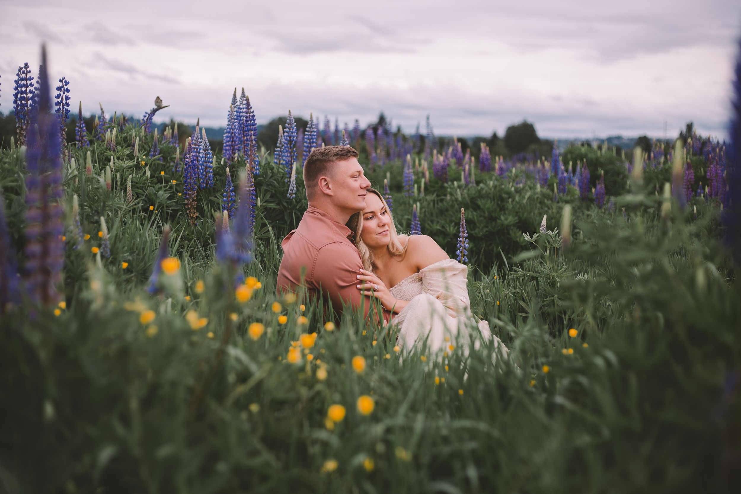 couples engagement photography session in lupine wildflower fields near Seattle, Washington