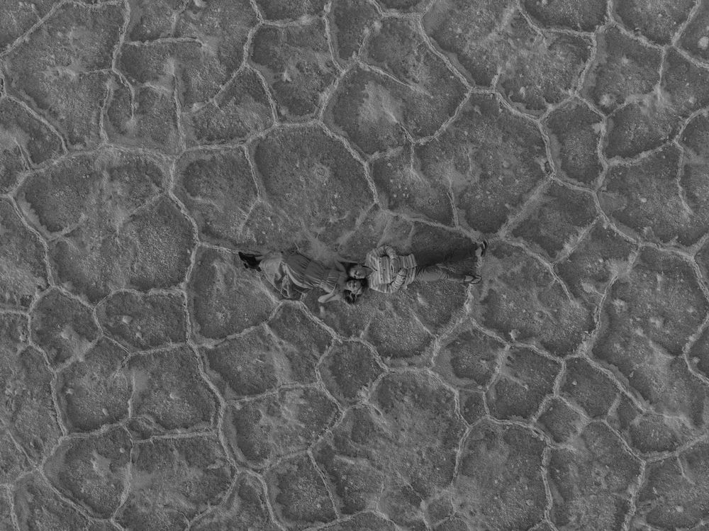 Textured surface pattern showing an organic cracked or broken stone design in gray tones.