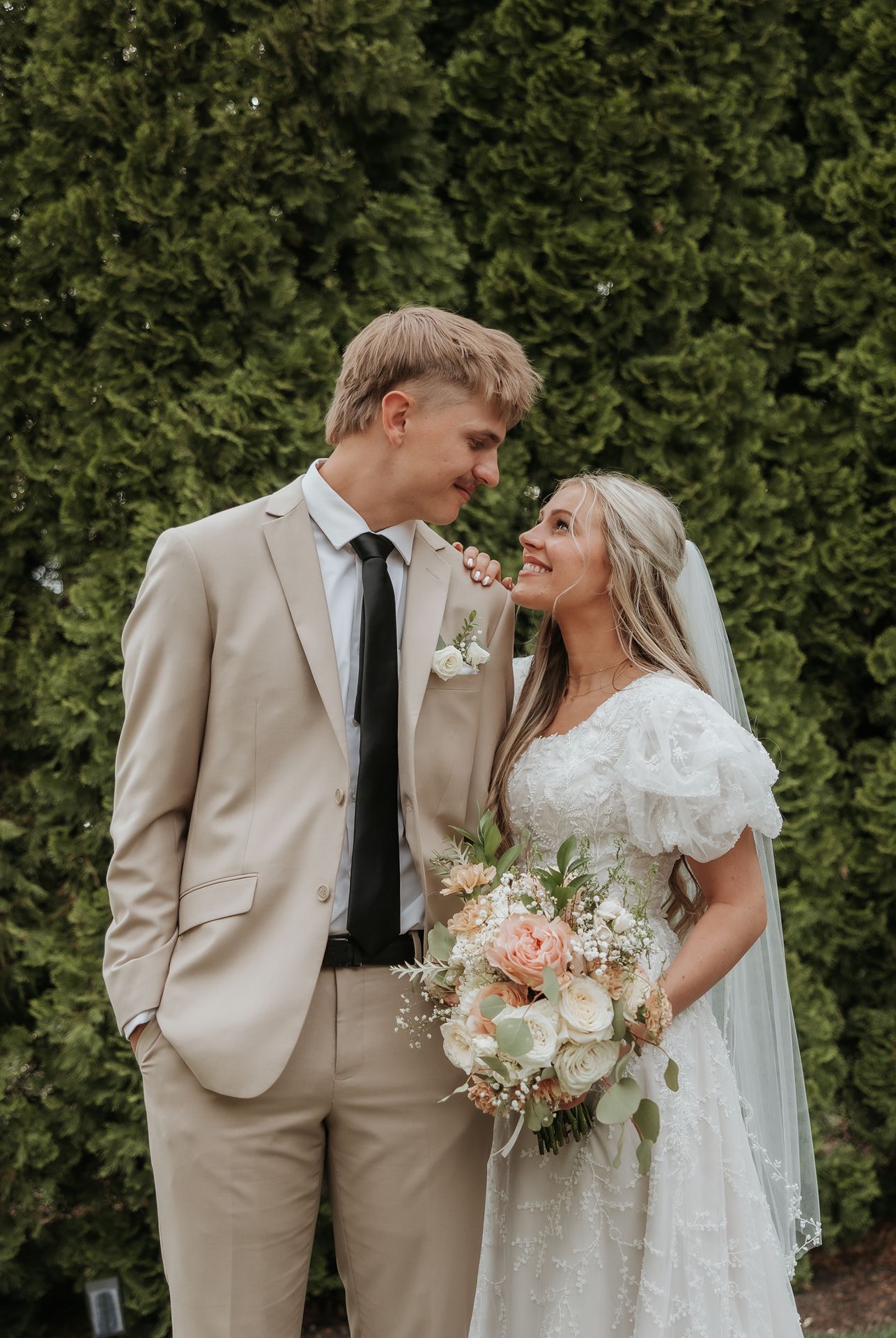 salt lake valley Romantic garden wedding portrait with bride holding blush and white floral bouquet.