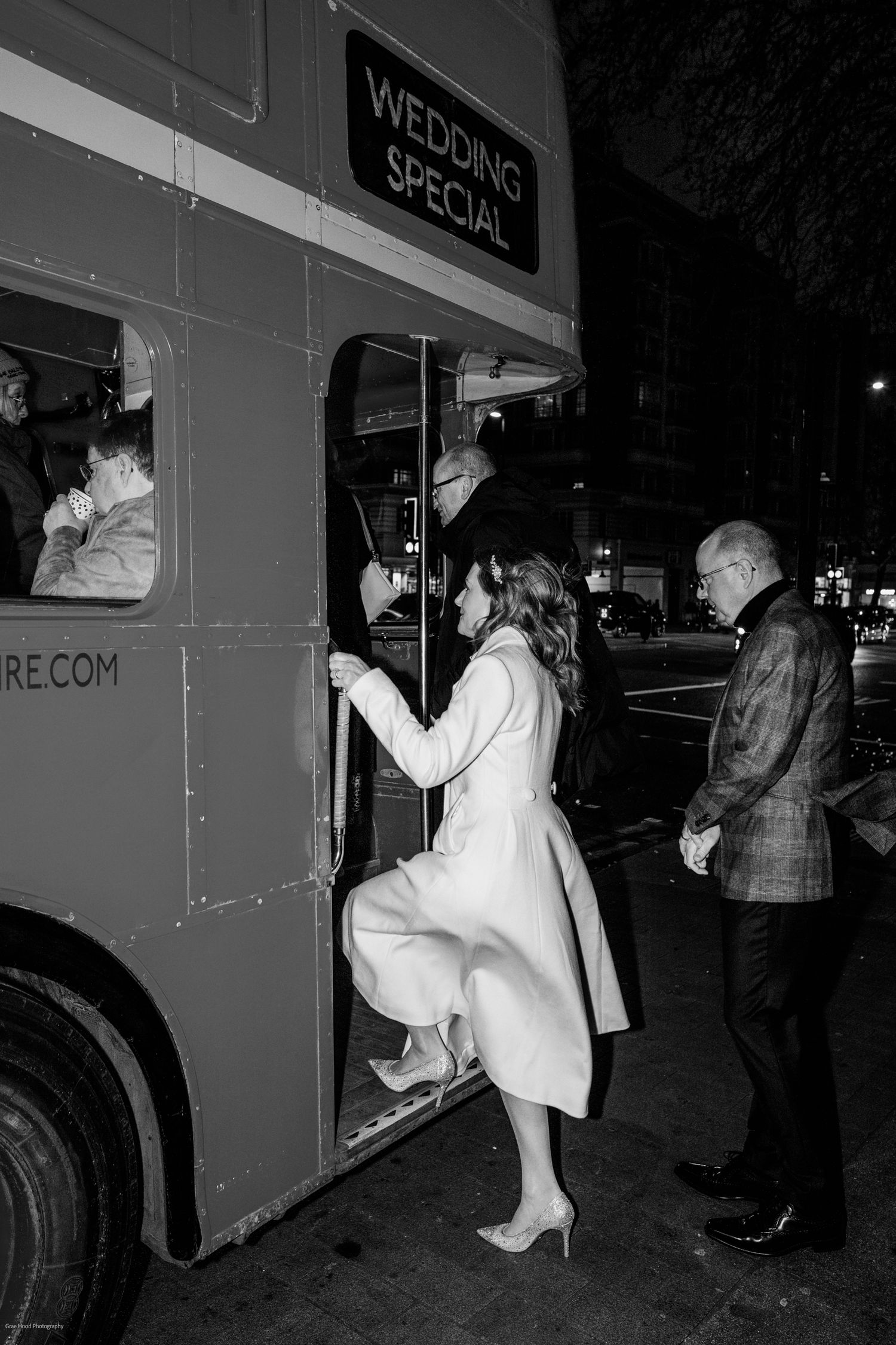 A sequence of black and white photos showing people entering and exiting a vintage bus at night.