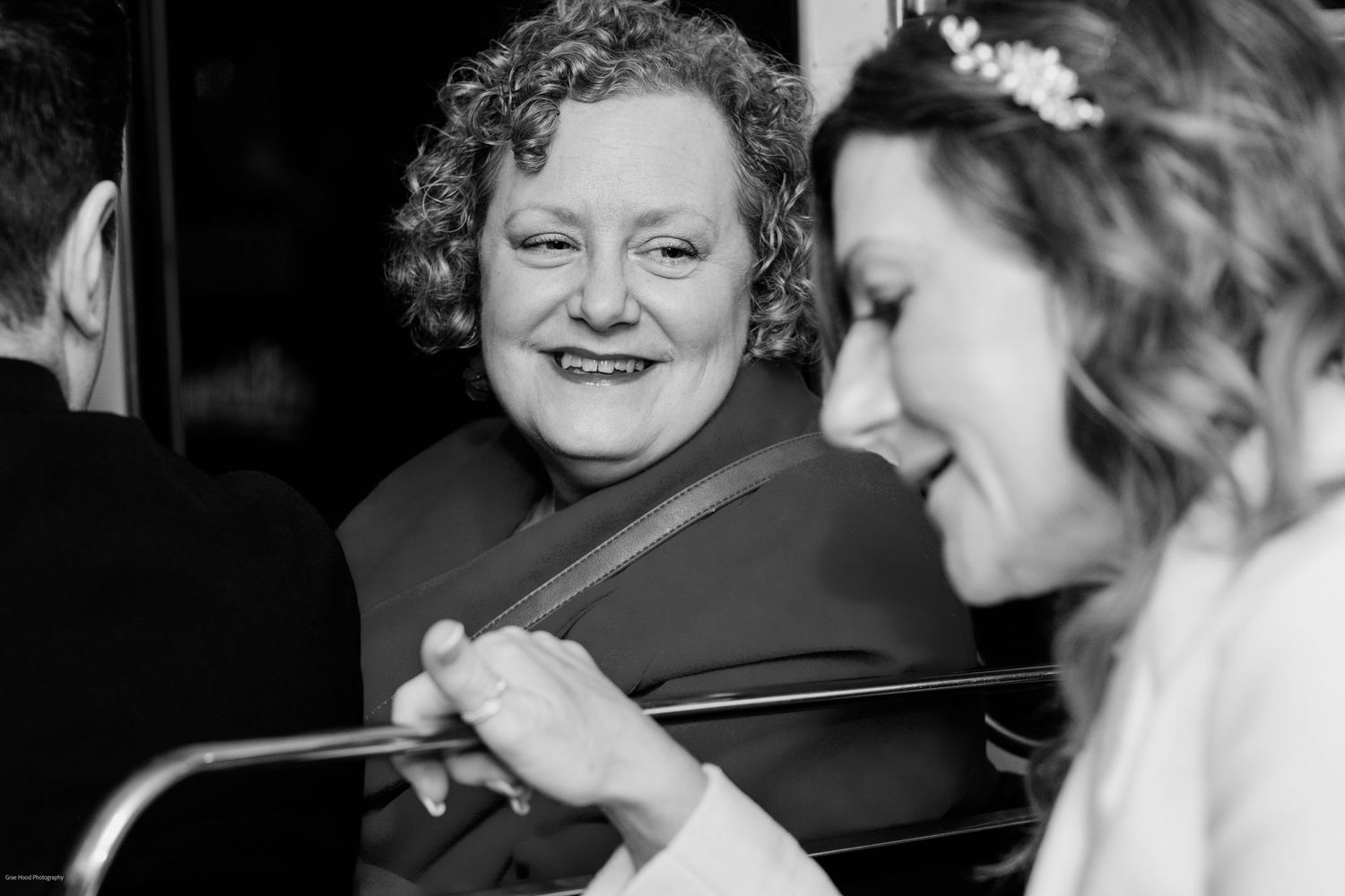 Black and white photo montage showing candid moments of people laughing and interacting at a social gathering.
