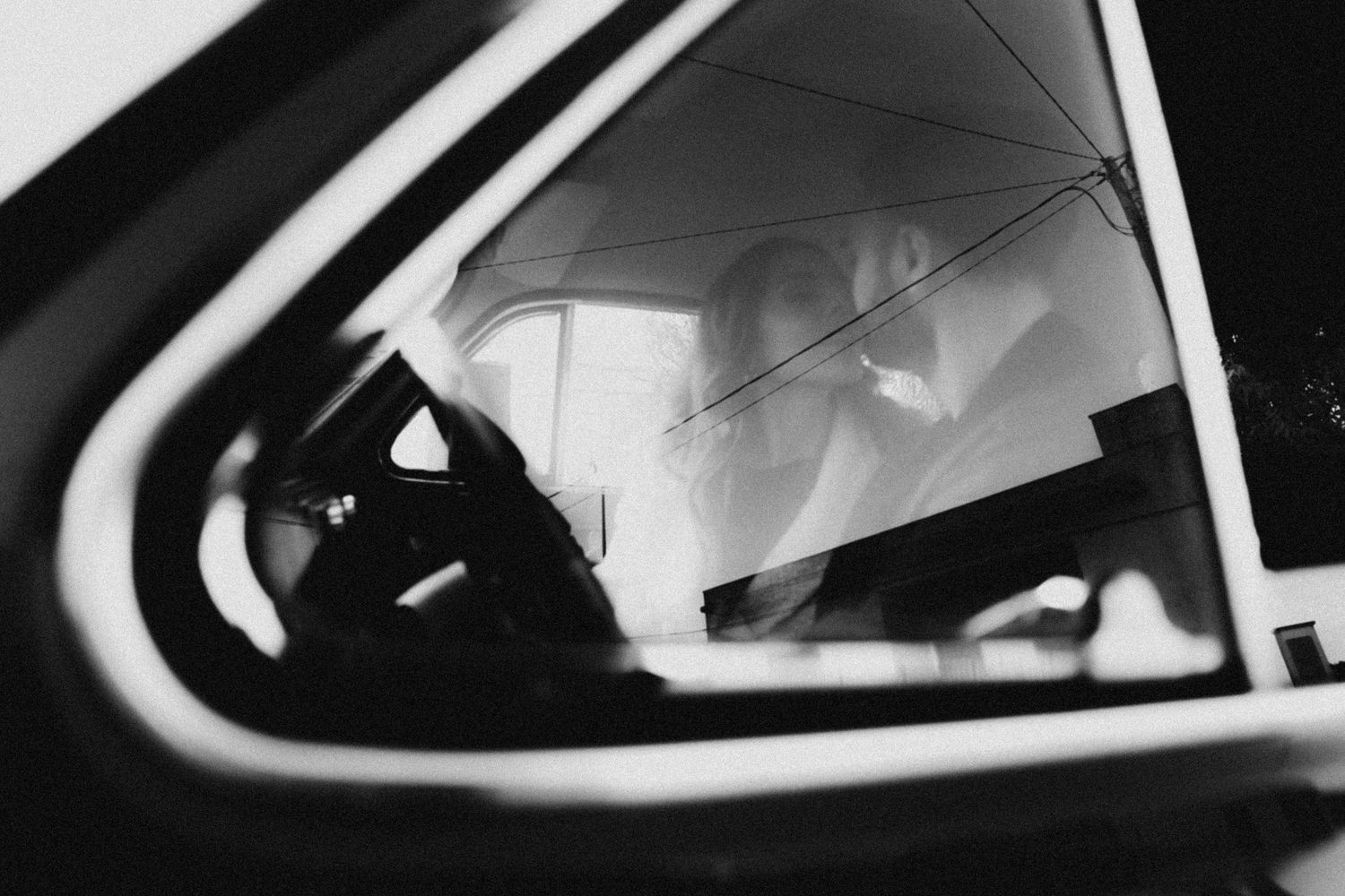A sequence of black and white images showing a car's interior rearview mirror in different angles and positions.