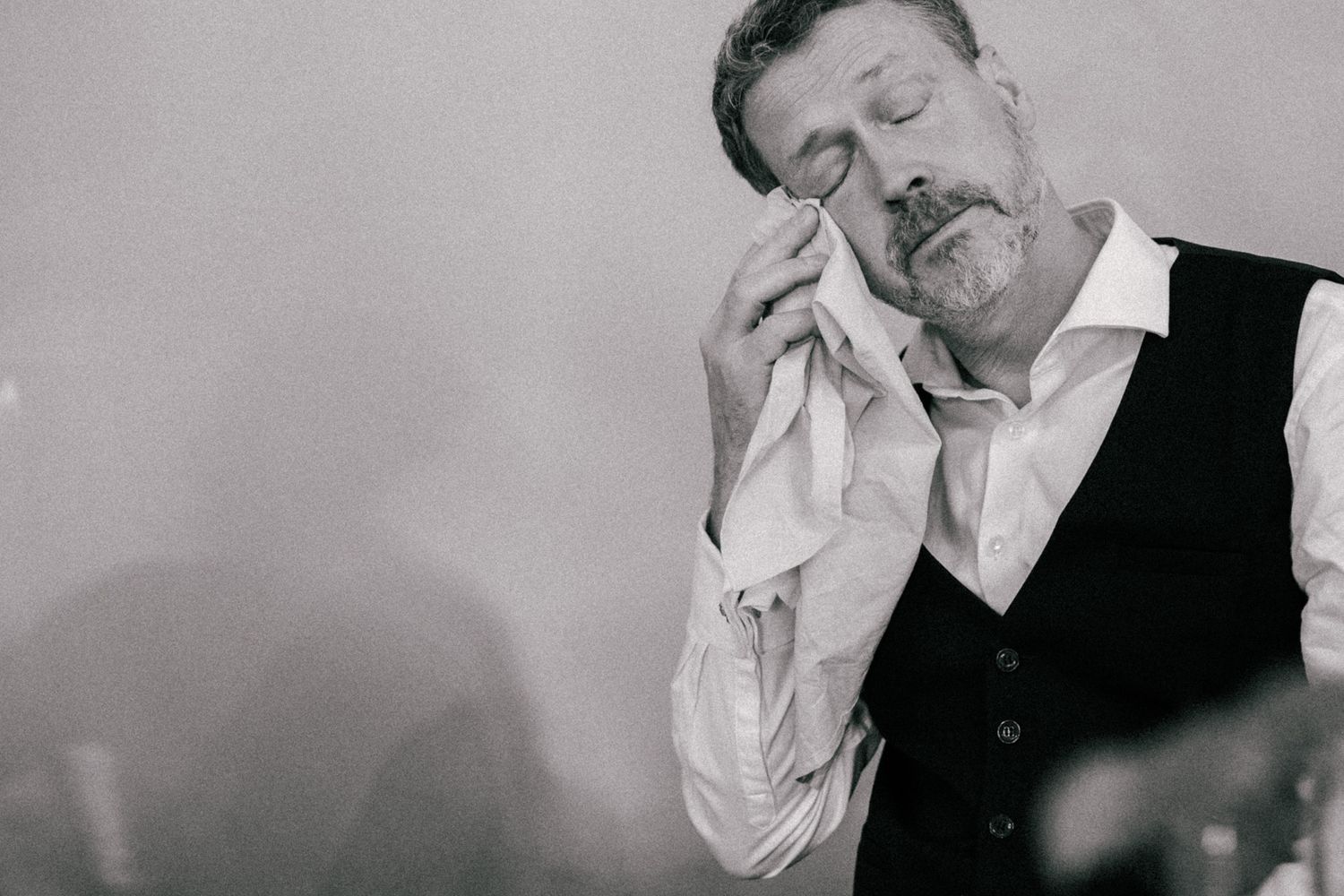 Black and white photo series showing romantic moments between a couple in formal attire at their wedding celebration.