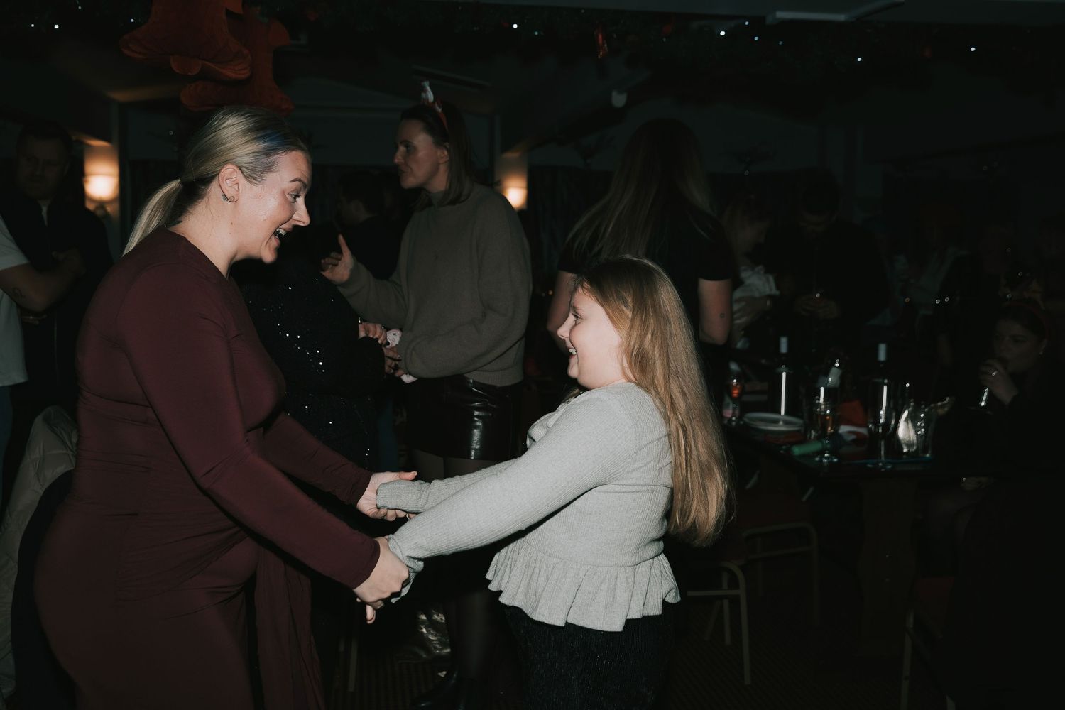 Couples dancing together in a darkened room during an evening celebration or event.