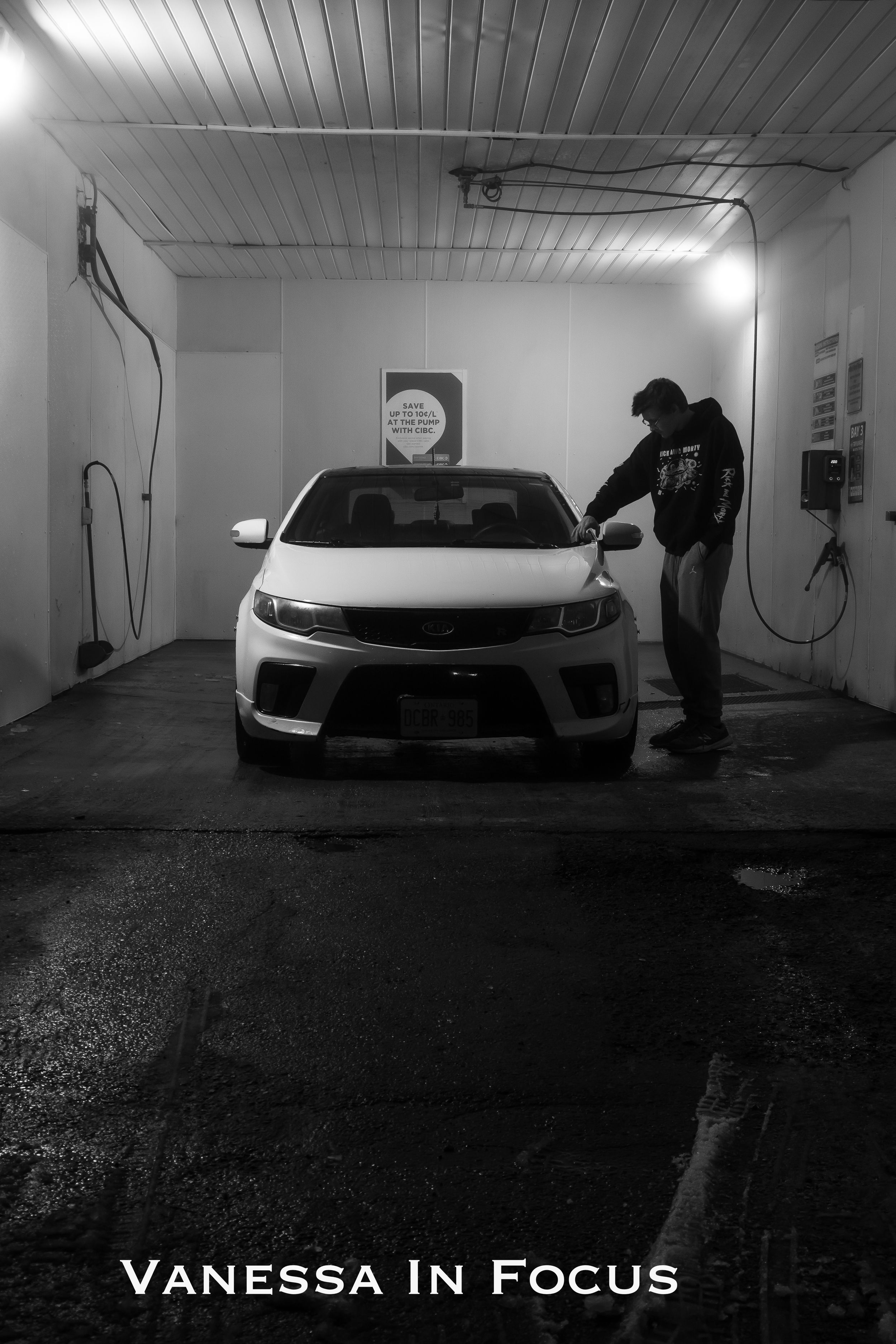 Black and white photo series showing dramatic angles of a modern car in a dimly lit garage space.