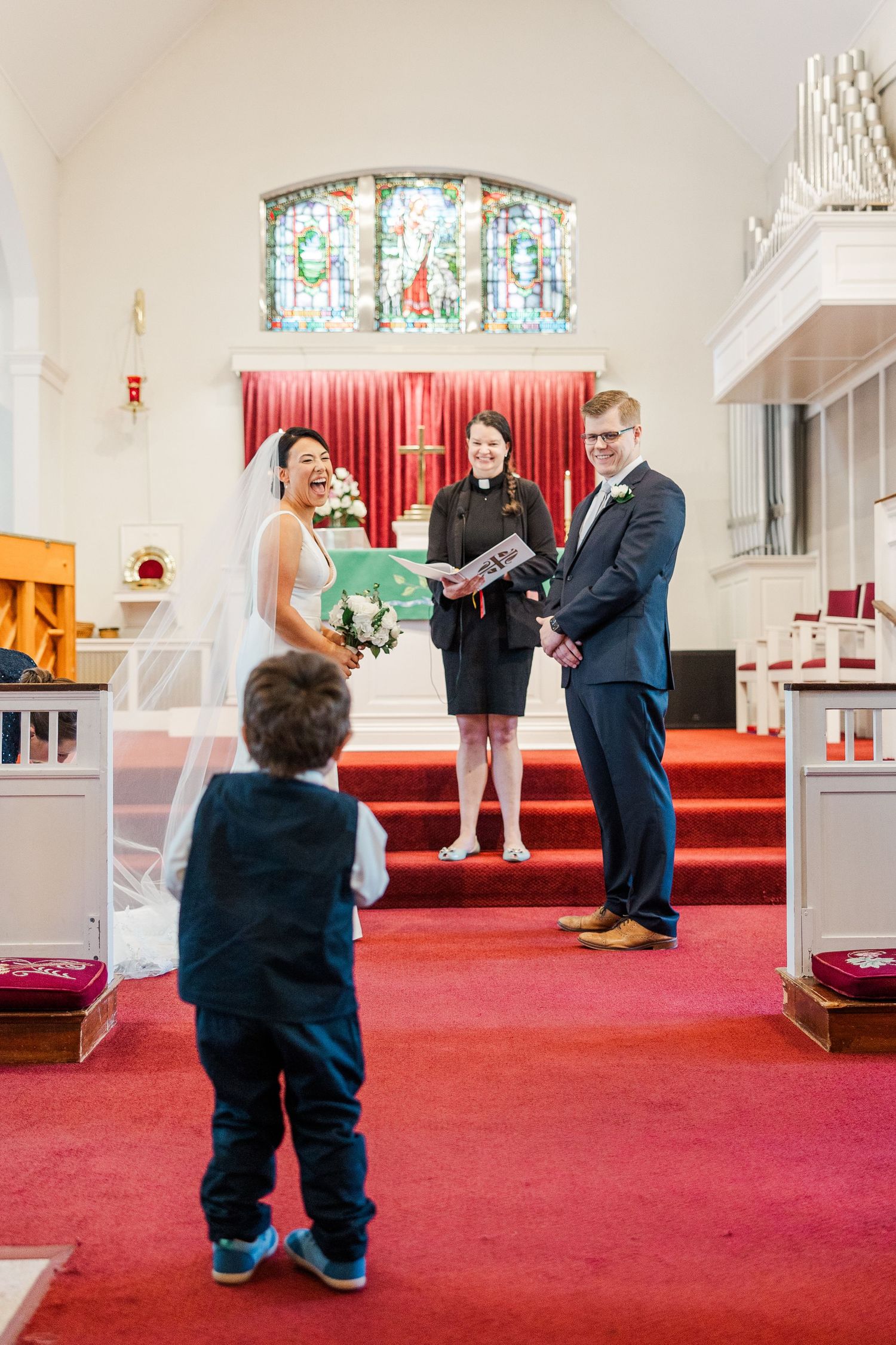 A sequence of photos showing a marriage proposal taking place on red carpeted steps inside a church sanctuary.