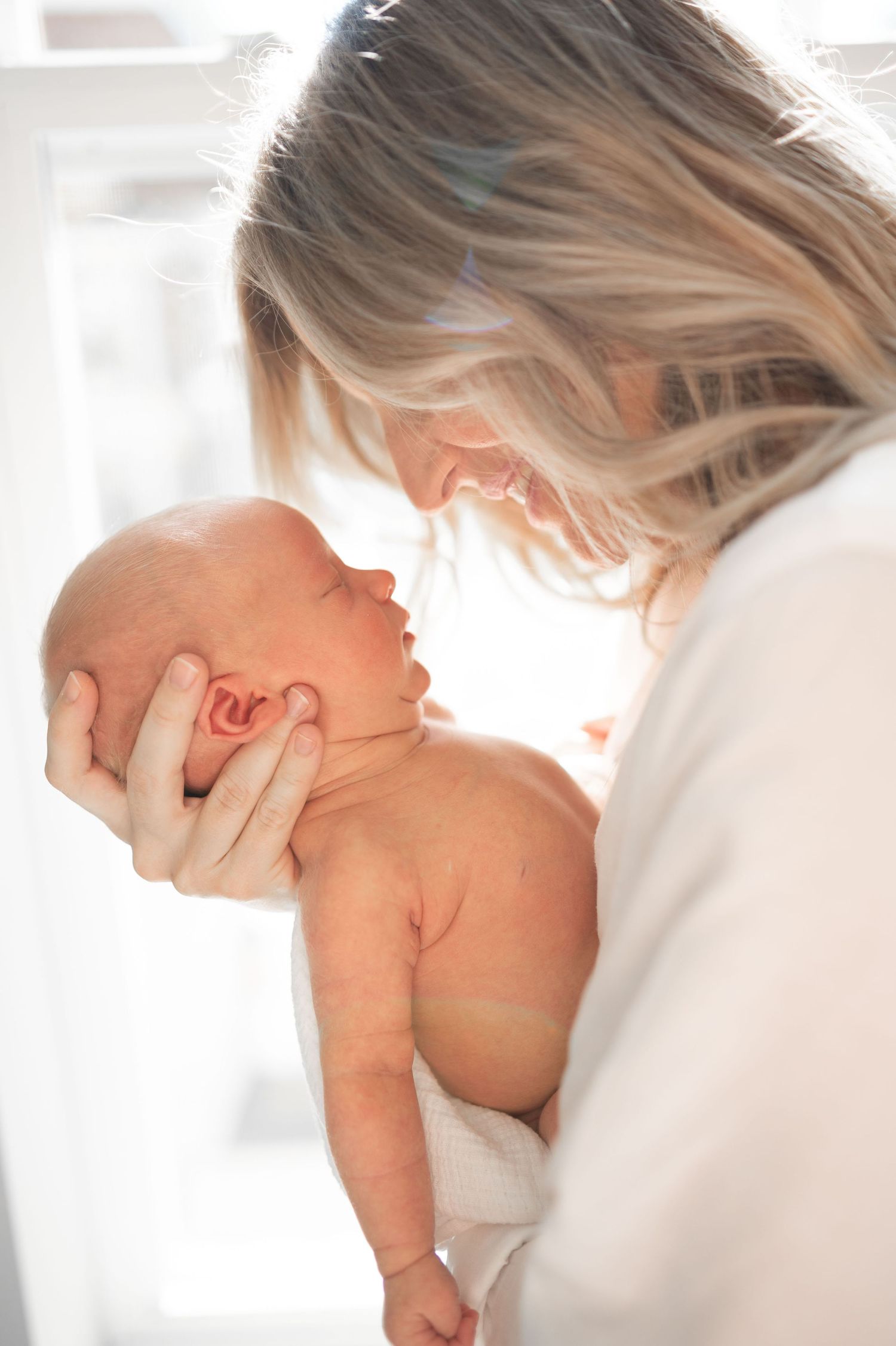 Mother holding newborn baby close up natural light Nashville newborn photography Thompson’s Station