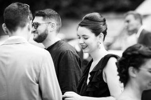 Black and white candid shots capturing natural reactions and laughter at an outdoor event.