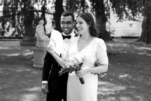 Black and white wedding portraits showing joyful moments between a couple outdoors.