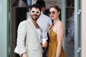 Summer portraits of couples in sunglasses enjoying drinks outside a cafe.