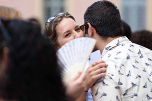 Casual outdoor portraits showing affectionate moments between a couple.