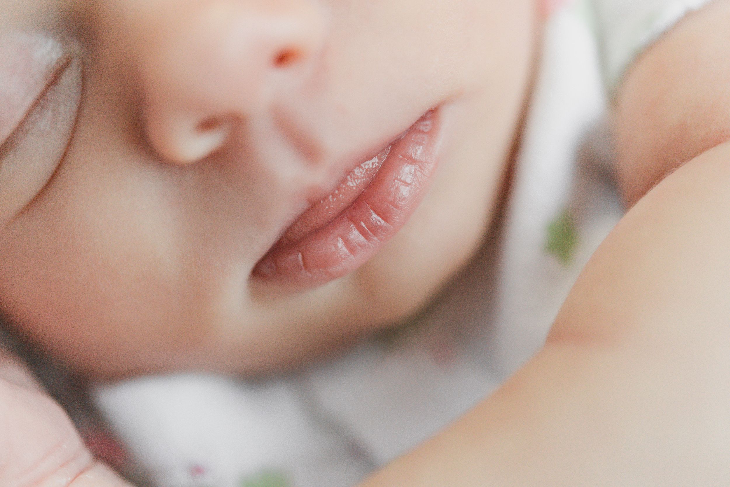Close up of sleeping infant's peaceful face and lips.