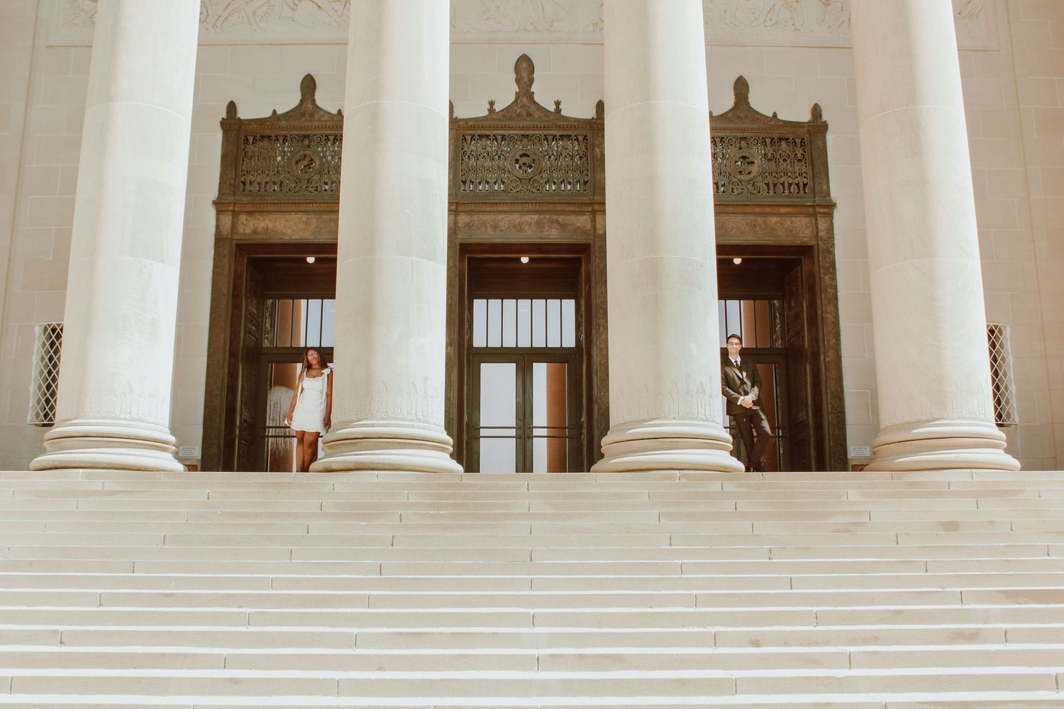 Classical building exterior featuring grand white columns and windows.