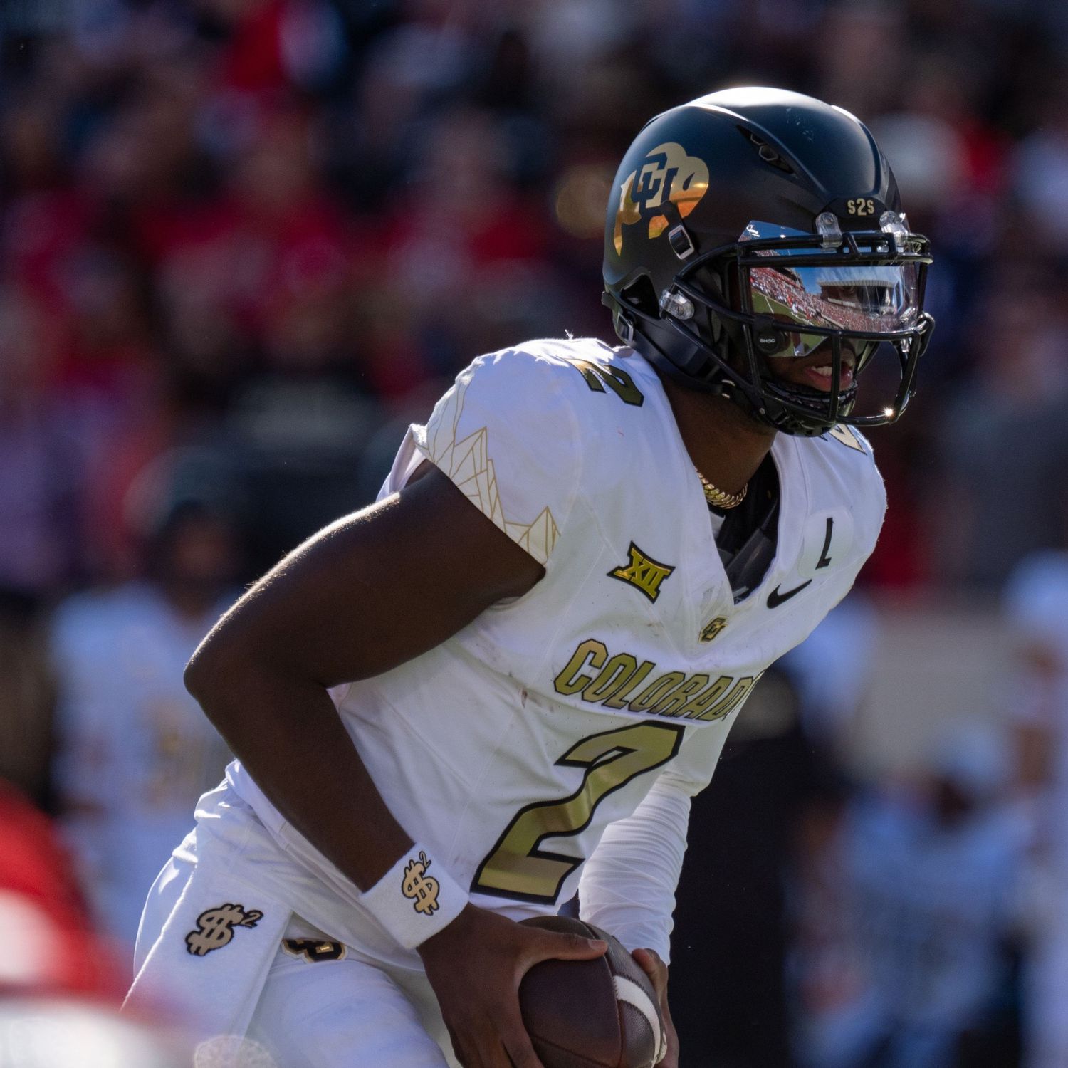 UCF football player wearing white jersey number 2 in game action against a blurred background of spectators.