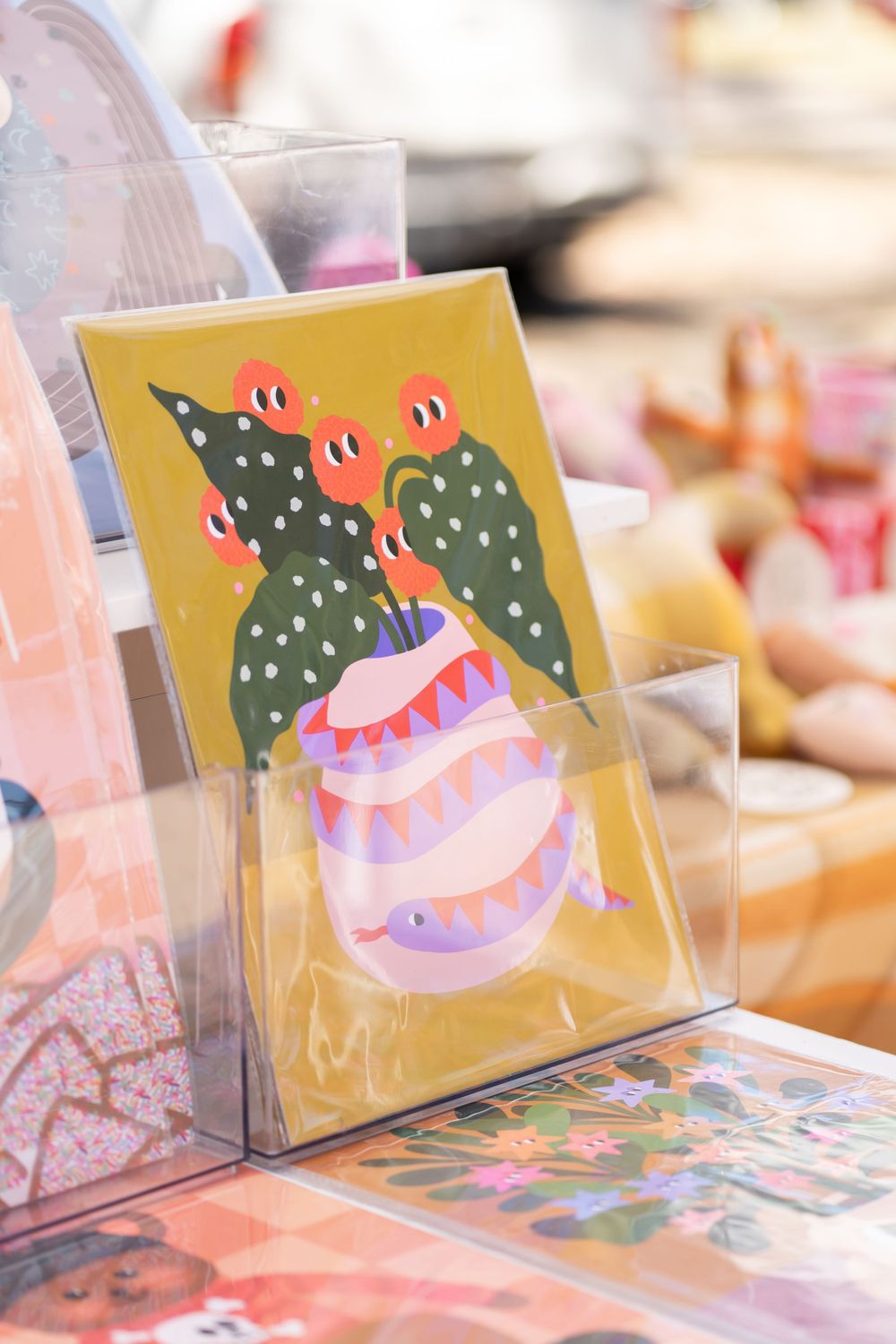 Colorful art card featuring whimsical cactus plants and vase design in bright colors.