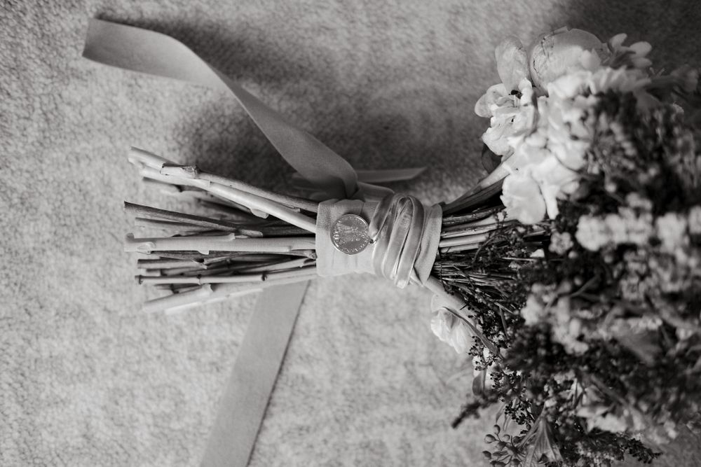 Close-up of a wrapped wedding bouquet stem with twine in monochrome.