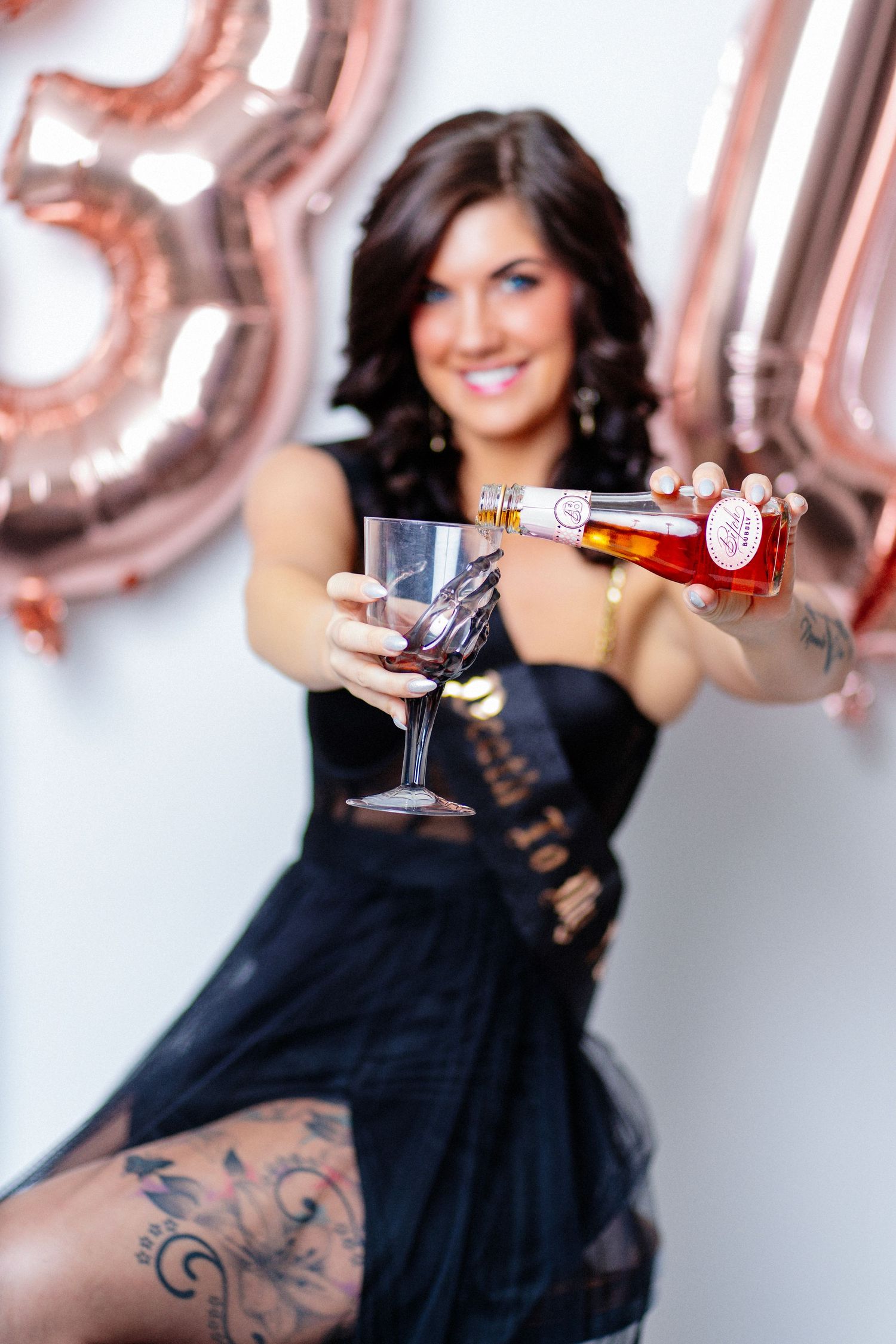 Photo of beautiful woman holding champagne bottle and glass to celebrate 30th birthday taken by Dandridge TN portrait photographer.