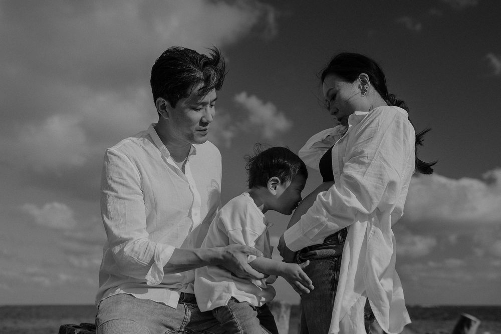 Joyful maternity family portraits in Puerto Morelos Mexico.
