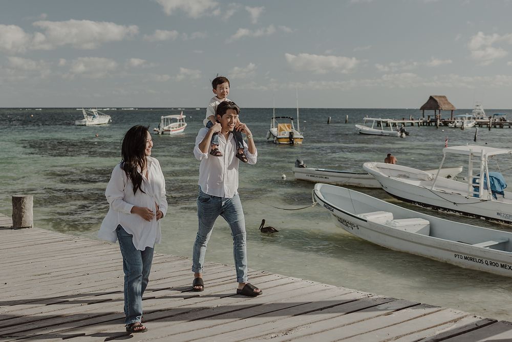 Candid family pregnancy portraits by the Caribbean in Riviera Maya.
