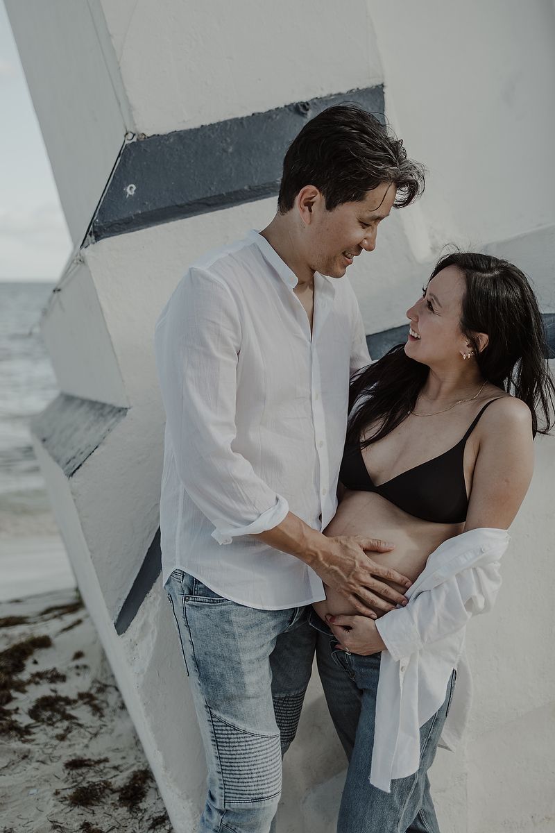 Romantic maternity couple portrait at the pier in Riviera Maya.