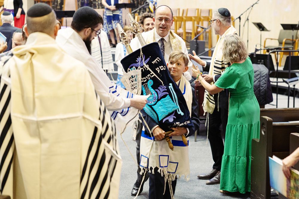 Bar Mitzvah service with boy carrying the Torah.  Photography at Kol Ami Synagogue in Tucson, AZ.  Amanda Rockafellow Photography.
