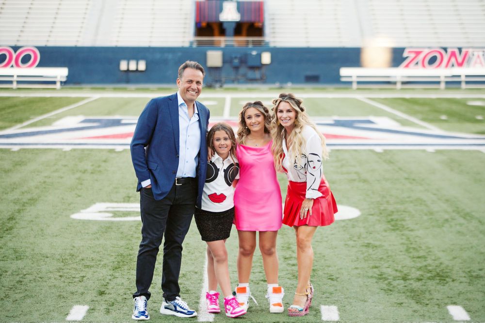 Family photographs in Tucson, AZ at the U of A football stadium. Football Coach Jedd Fisch and family. Aviator Nation themed party.
