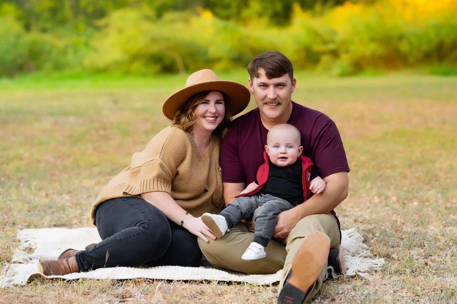 Family of 3 together on blanket during mesquite fall family mini photo session by dallas area family and lifestyle newborn photographer