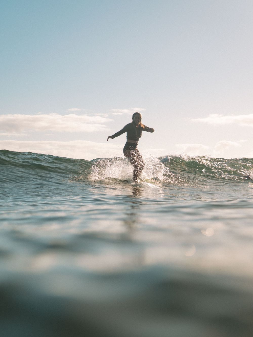 woman surfing in morning light at Seal Rocks near Newcastle NSW