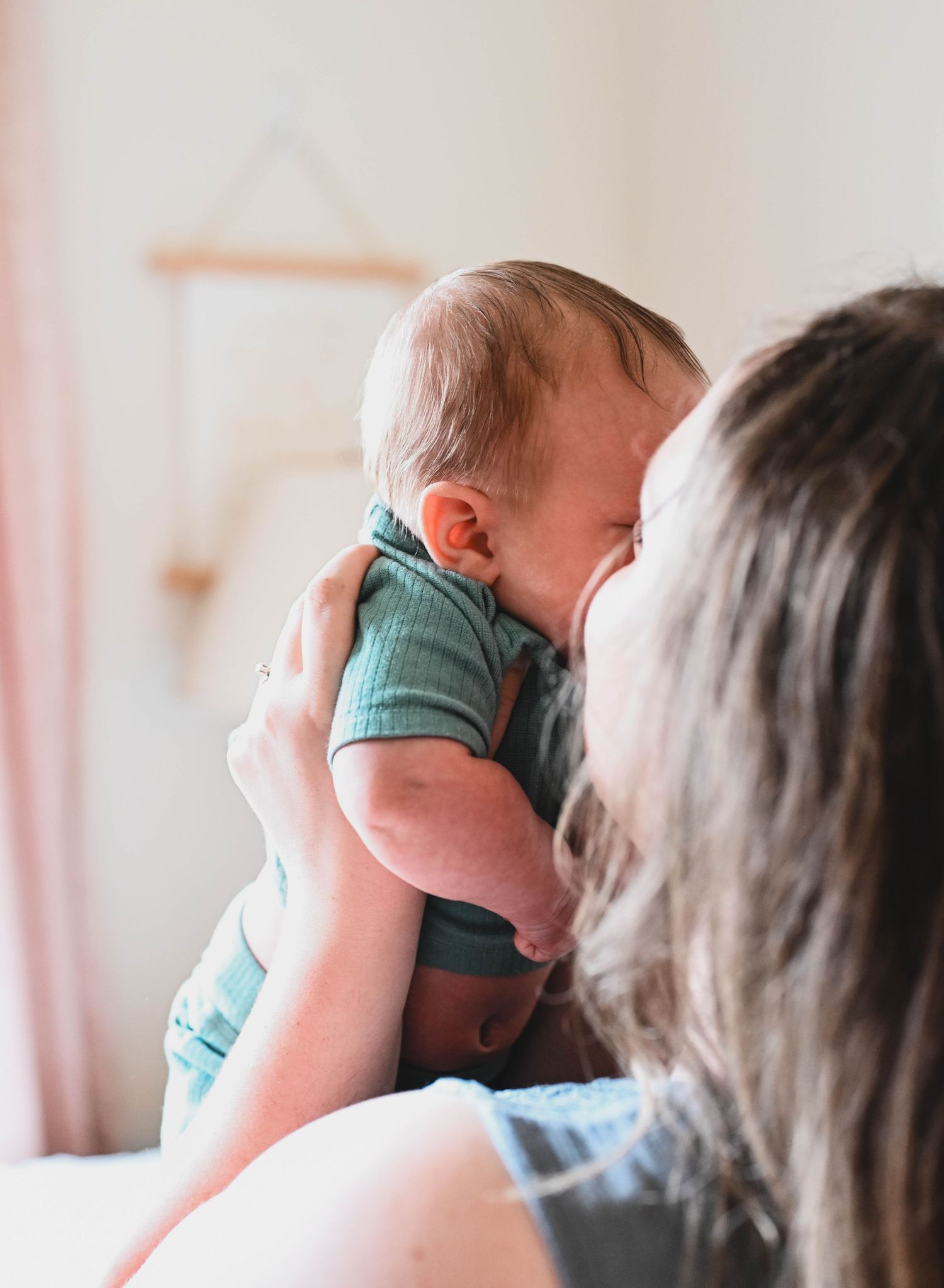 Mom kissing baby boy during newborn session, East Greenbush, NY