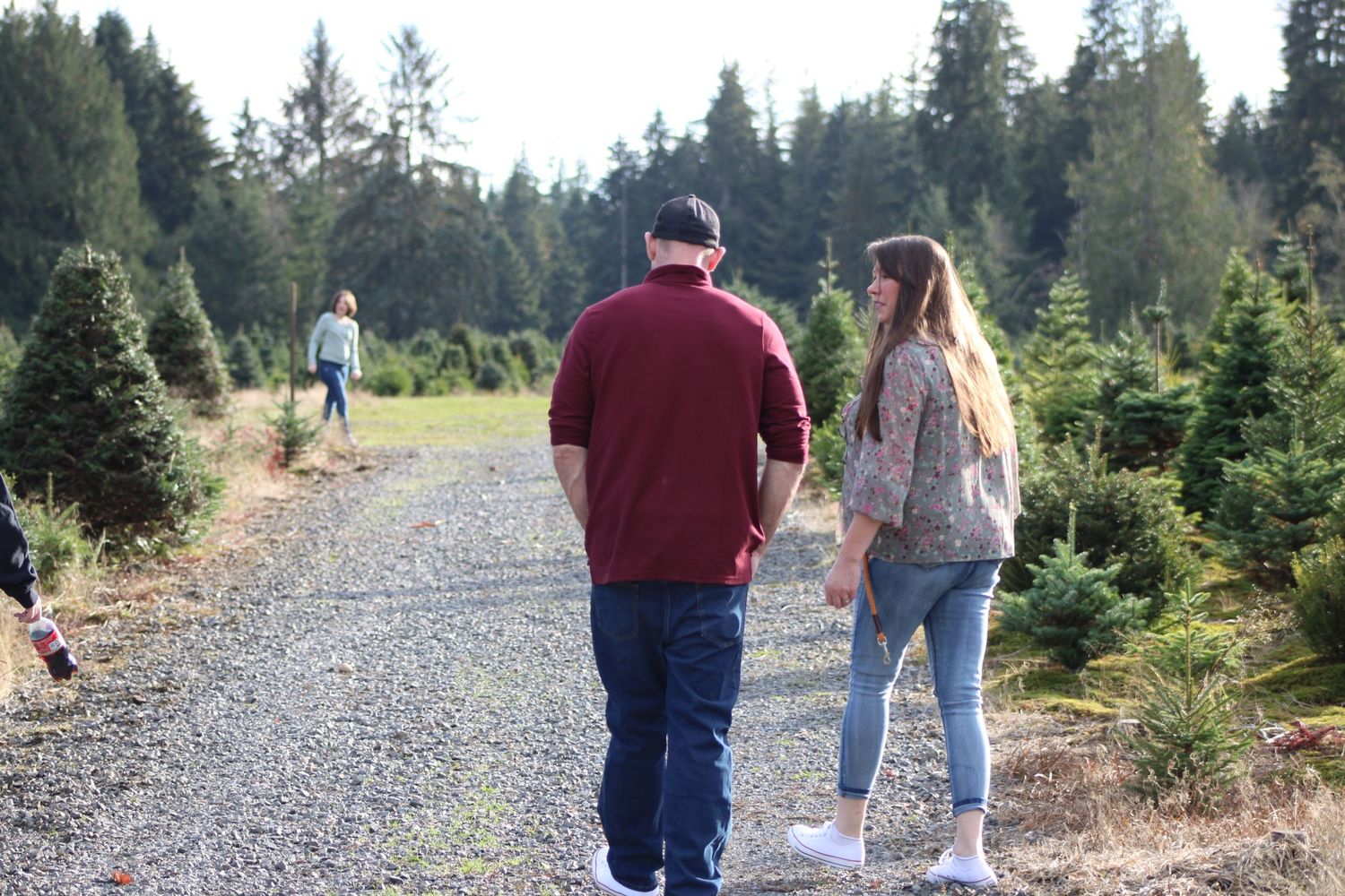 Couple walking down forest trail together, candid outdoor lifestyle moment
