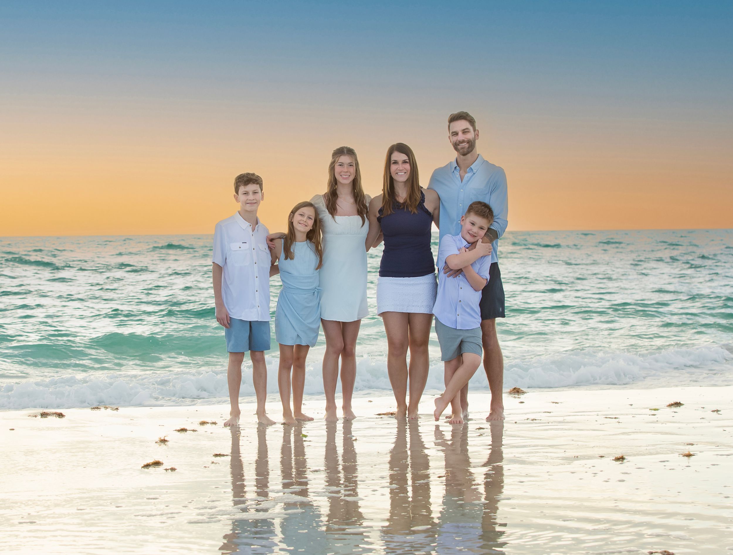 happy family beach photoshoot Longboat Key sunset white sand birds flying background natural candid moment Florida