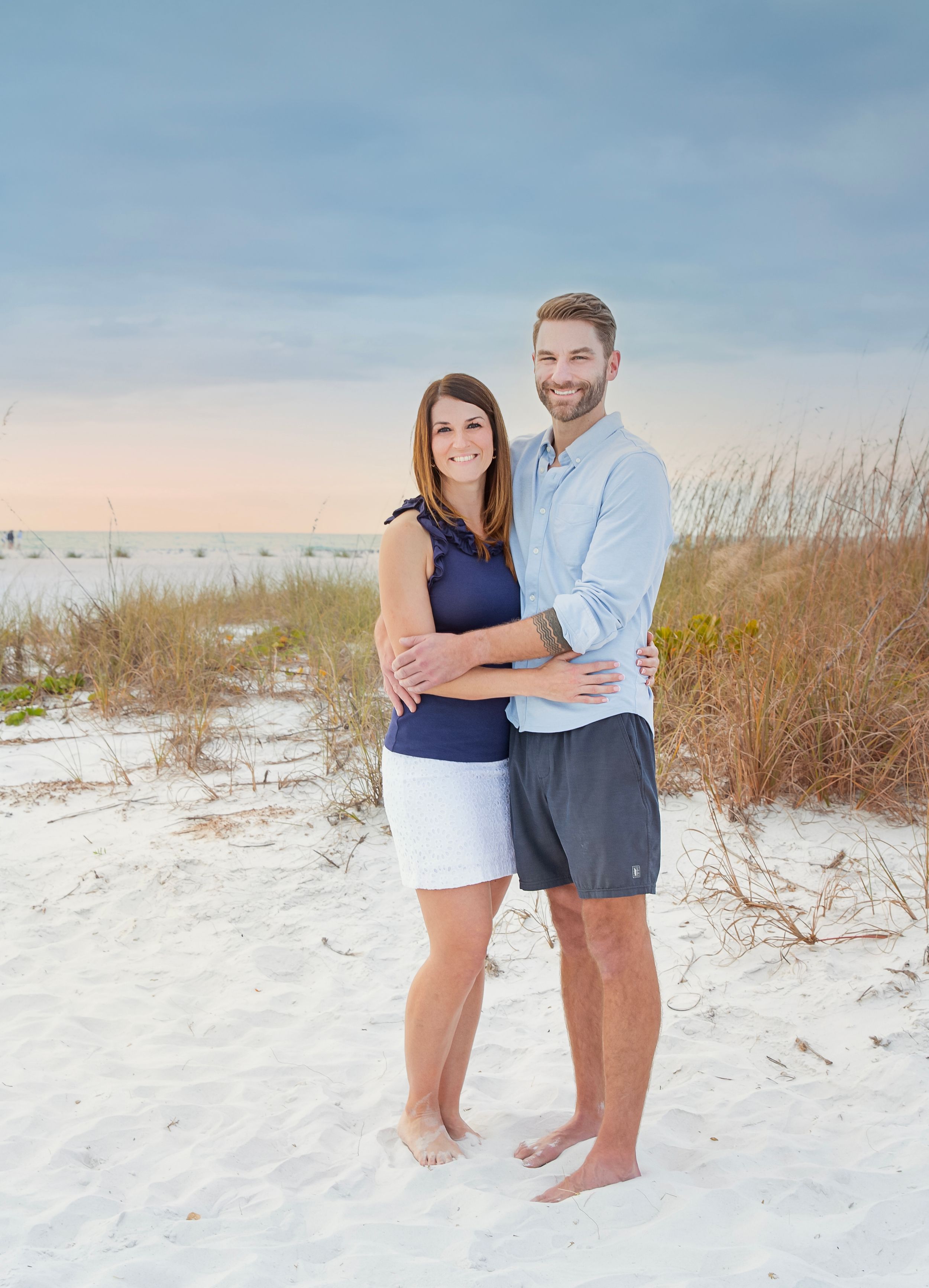 happy family beach photoshoot Longboat Key sunset white sand birds flying background natural candid moment Florida