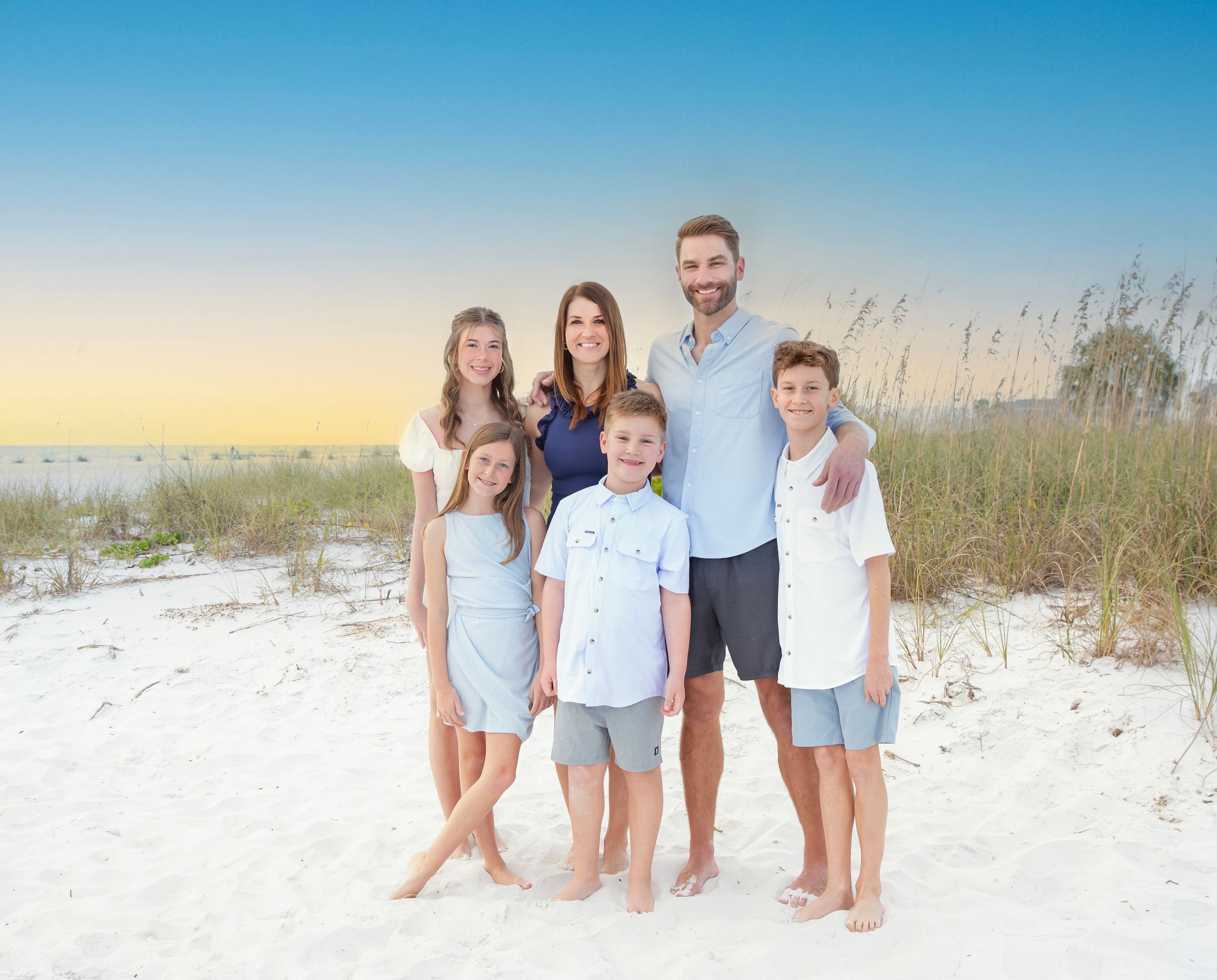 happy family beach photoshoot Longboat Key sunset white sand birds flying background natural candid moment Florida