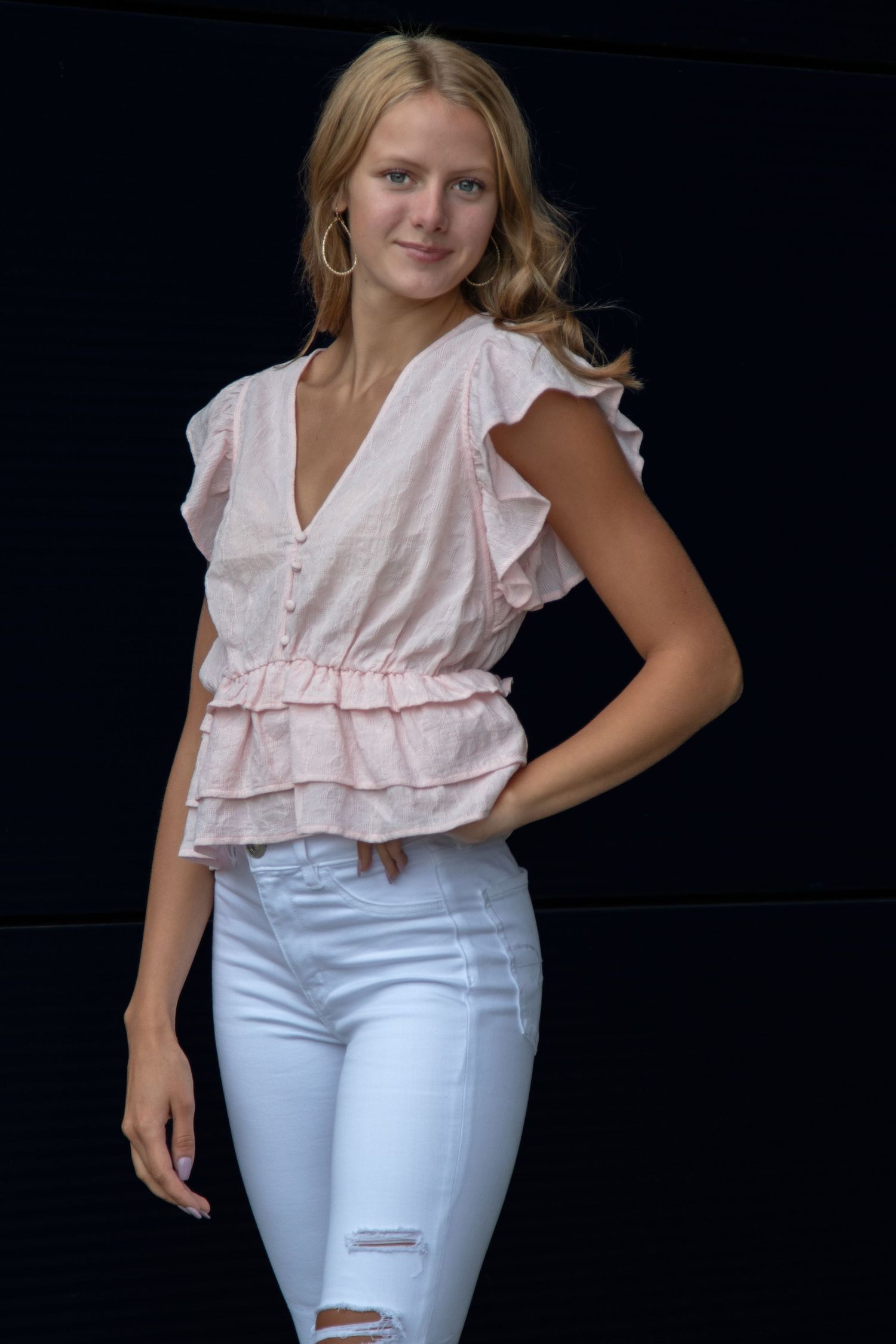 portrait of a young lady with her hand on her hip