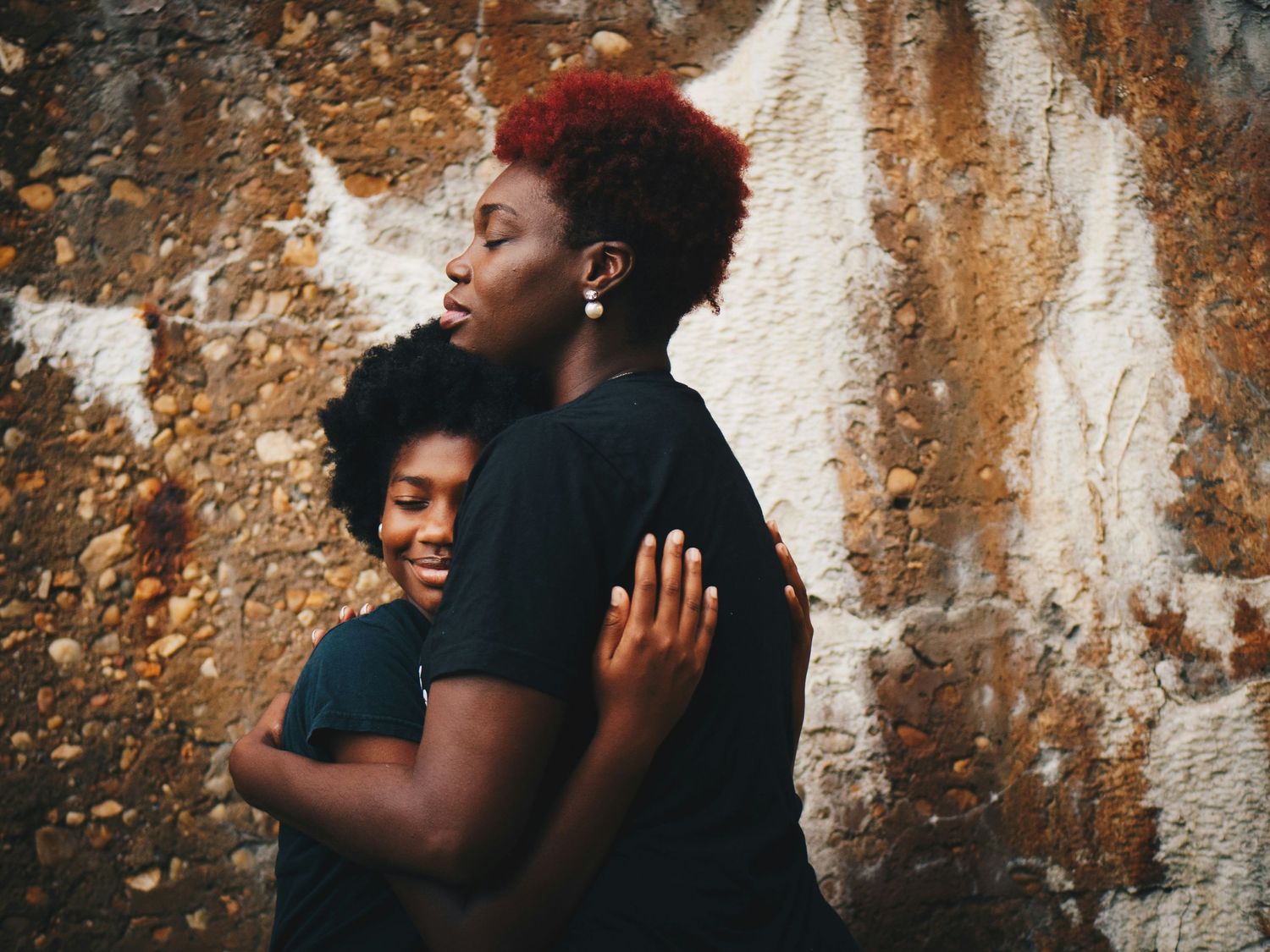 Mother and daughter hug during portrait session