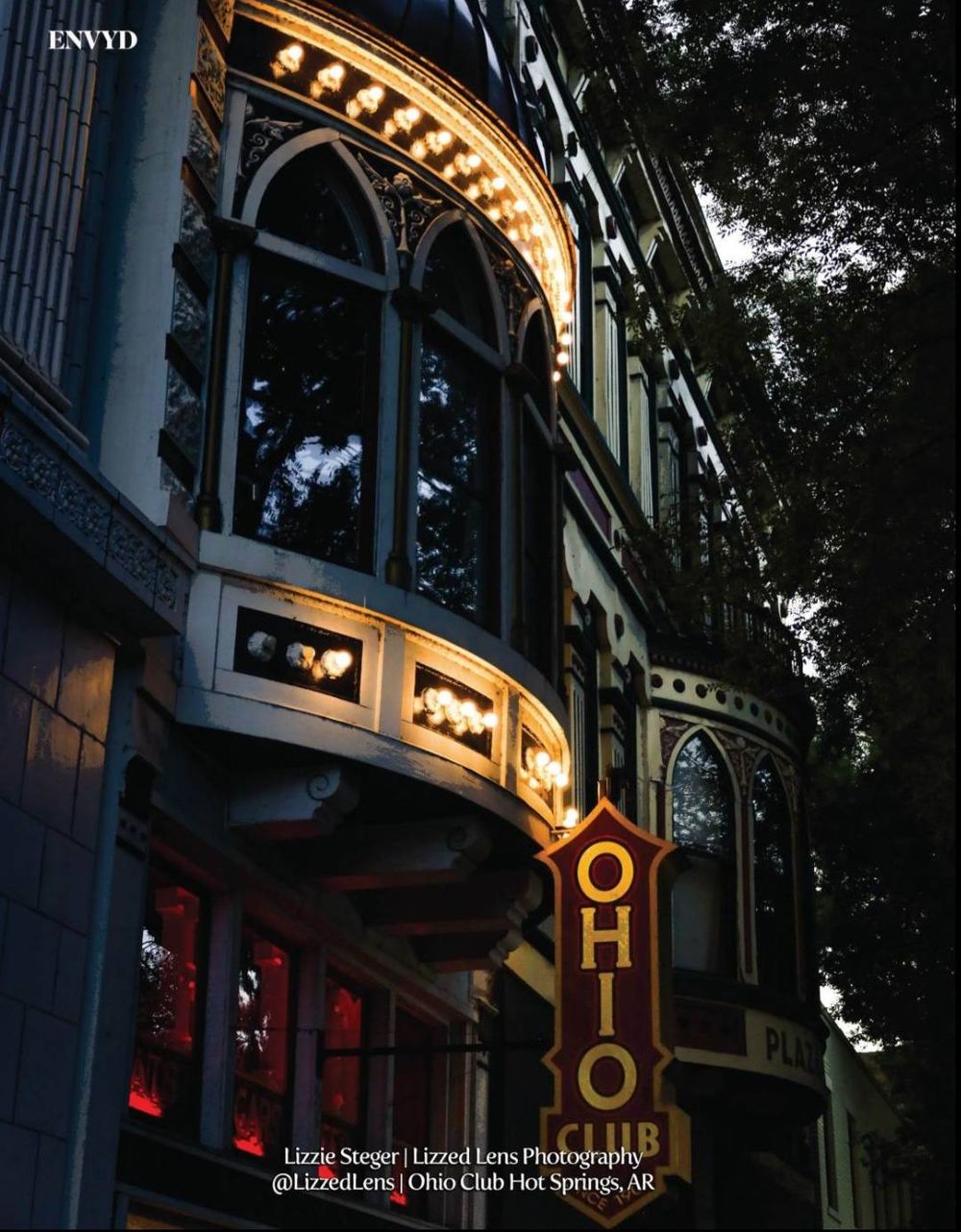 The illuminated Ohio Club sign glows at night on a historic building in Hot Springs, AR.