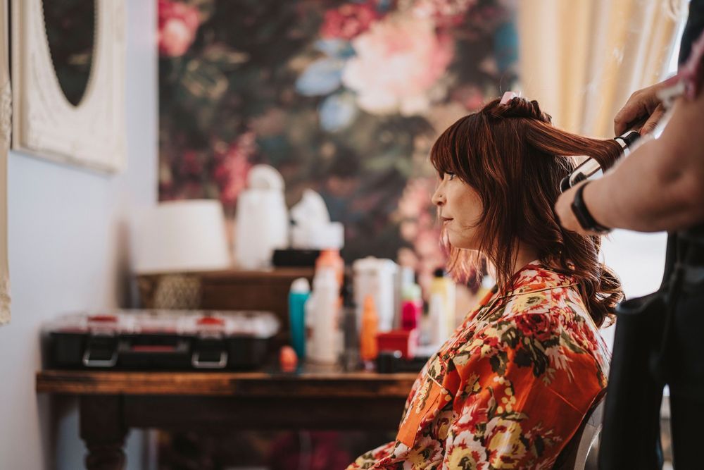 Getting ready for a wedding with bridesmaids and guests in a stylish indoor venue filled with natural light.