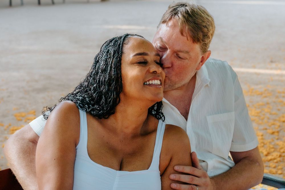Raquel & Greg holding hands and smiling during their anniversary photoshoot.