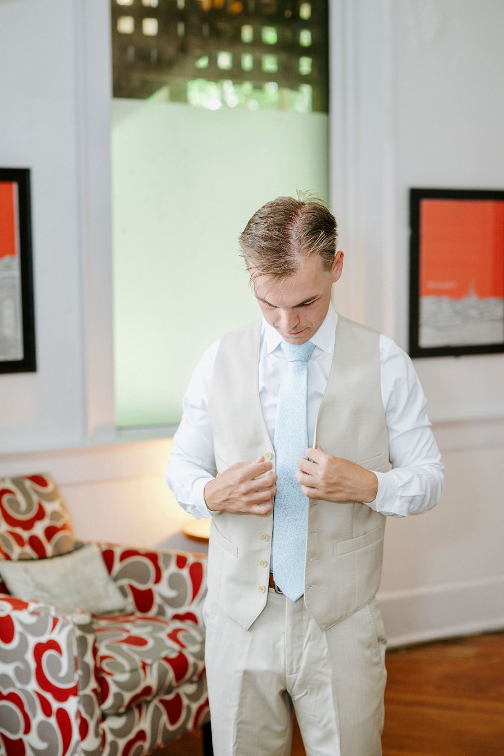 A formal scene showing light-colored suits with pale blue ties in an indoor setting.