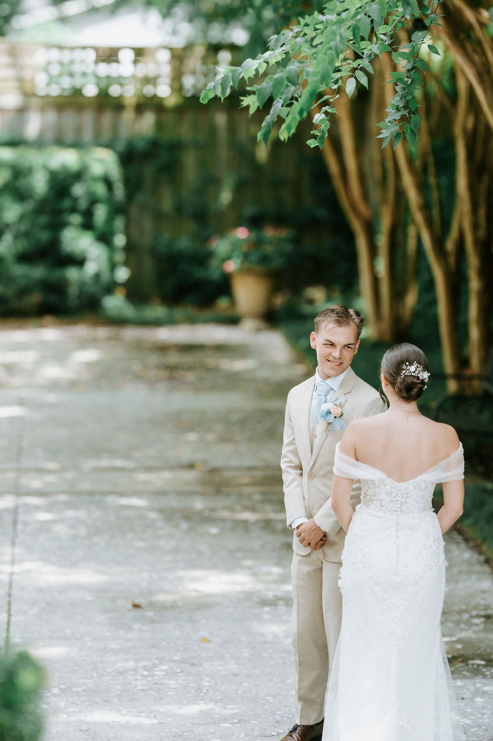 A tender first look moment between a couple at an outdoor garden wedding venue.