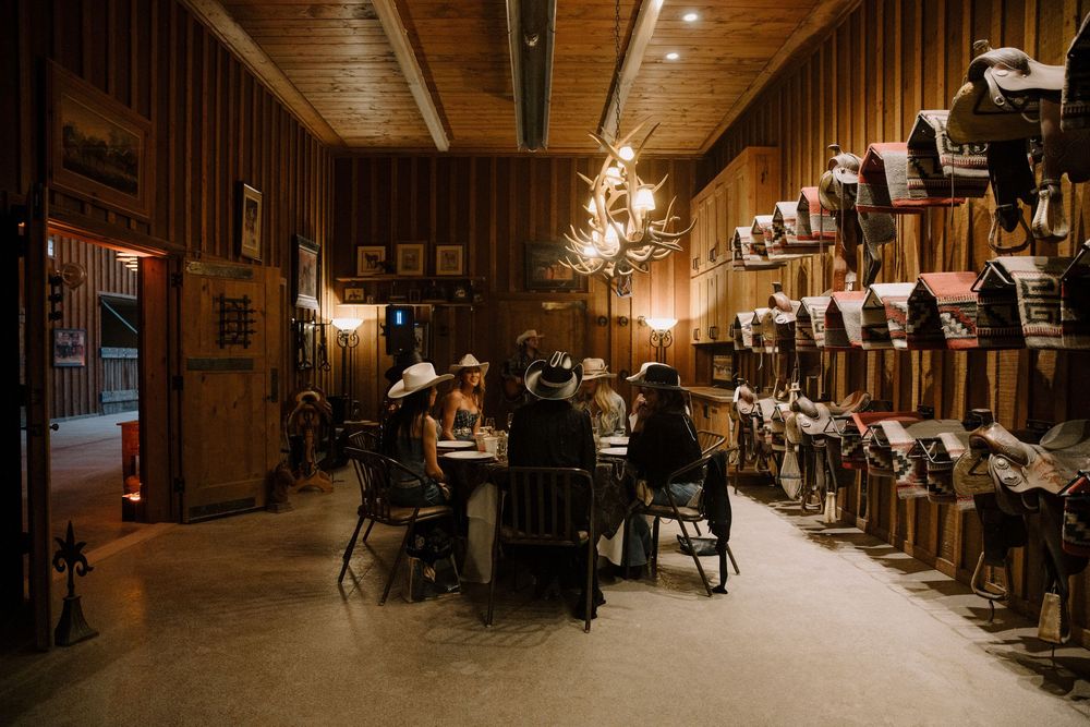 Rustic wooden interior of a barn or lodge with warm lighting and wooden beams.