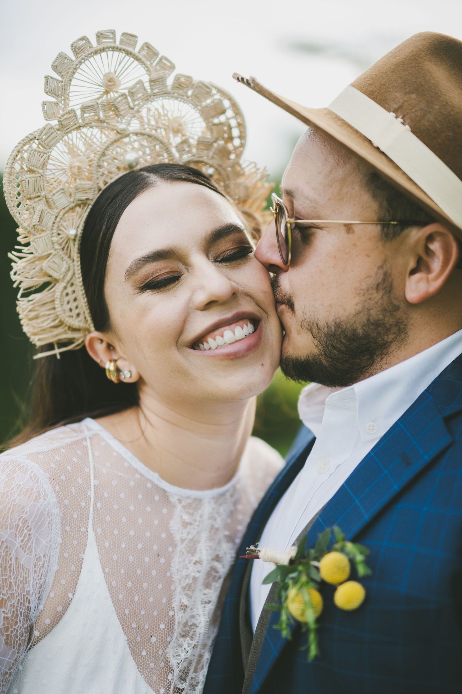 Close-up sequence of romantic wedding day kiss in vintage style with bride wearing ornate crown and delicate lace.