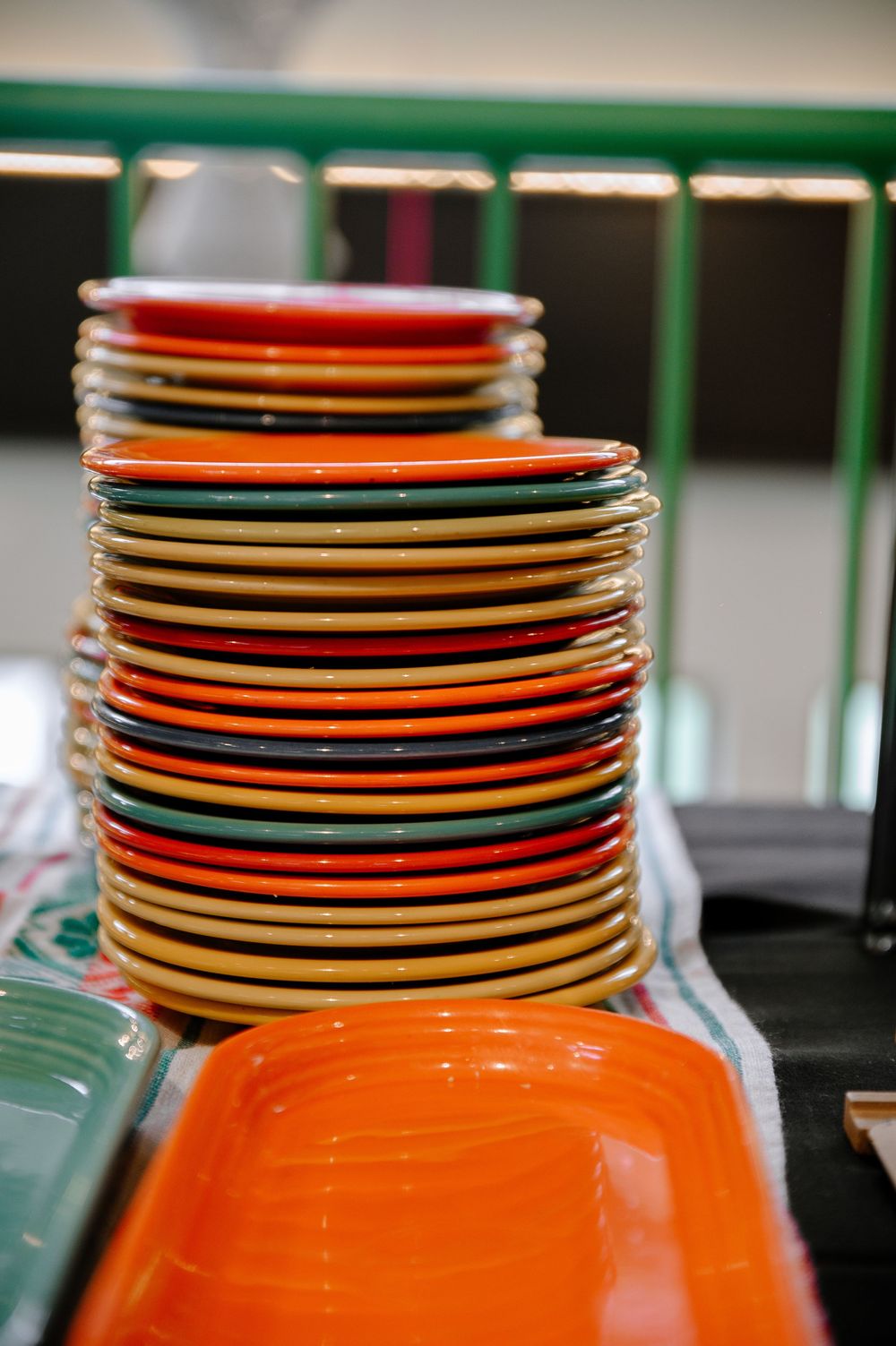 Stack of colorful plates arranged neatly in orange and black.